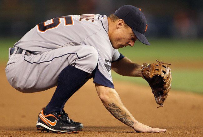 KANSAS CITY, MO - JULY 07:  Brandon Inge #15 of the Detroit Tigers rubs the dirt during the game against the Kansas City Royals on July 7, 2011 at Kauffman Stadium in Kansas City, Missouri.  (Photo by Jamie Squire/Getty Images)