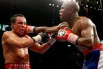 LAS VEGAS - SEPTEMBER 19:  Floyd Mayweather Jr. (R) hits Juan Manuel Marquez in the 11th round of their fight at the MGM Grand Garden Arena September 19, 2009 in Las Vegas, Nevada. Mayweather won by unanimous decision.  (Photo by Ethan Miller/Getty Images)