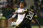 CARSON, CA - SEPTEMBER 11:  David Beckham #23 of the Los Angeles Galaxy flicks a pass over Shaun Francis #29 of the Columbus Crew during their MLS match at The Home Depot Center on September 11, 2010 in Carson, California. The Galaxy defeated Crew 3-1.  (Photo by Victor Decolongon/Getty Images)