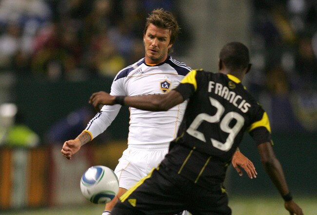 CARSON, CA - SEPTEMBER 11:  David Beckham #23 of the Los Angeles Galaxy flicks a pass over Shaun Francis #29 of the Columbus Crew during their MLS match at The Home Depot Center on September 11, 2010 in Carson, California. The Galaxy defeated Crew 3-1.  (Photo by Victor Decolongon/Getty Images)