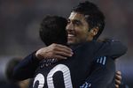 VALENCIA, SPAIN - DECEMBER 12:  Ezequiel Garay (R) of Real Madrid celebrates his goal with his teammate Gonzalo Higuain during the La Liga Match between Valencia and Real Madrid at Estadio Mestalla on December 12, 2009 in Valencia, Spain. Real Madrid won 3-2.  (Photo by Manuel Queimadelos Alonso/Getty Images)