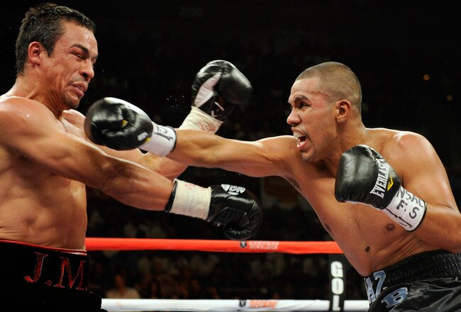 LAS VEGAS - JULY 31:  Juan Diaz  (R) throws a right at WBA/WBO lightweight champion Juan Manuel Marquez in the third round of their bout at the Mandalay Bay Events Center July 31, 2010 in Las Vegas, Nevada. Marquez retained his WBA and WBO lightweight championship belts with a unanimous-decision victory over Diaz.  (Photo by Ethan Miller/Getty Images)
