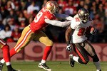 SAN FRANCISCO - NOVEMBER 21:  Micheal Spurlock #81 of the Tampa Bay Buccaneers tries turnover outrun Manny Lawson #99 of the San Francisco 49ers at Candlestick Park on November 21, 2010 in San Francisco, California.  (Photo by Ezra Shaw/Getty Images)