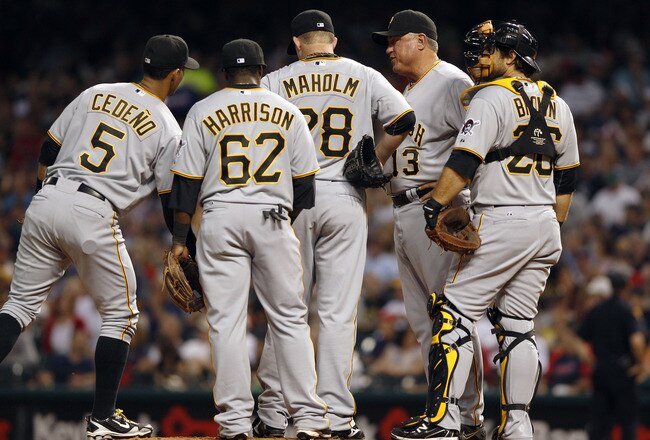 CLEVELAND, OH - JUNE 18:   Paul Maholm #28 of the Pittsburgh Pirates is removed from the game by Manager Clint Hurdle #13 as Ronny Cedeno #5, Josh Harrison #62, and Dusty Brown #26 look on in the seventh inning against the Cleveland Indians during  their game on June 18, 2011 at Progressive Field in Cleveland, Ohio.  The Indians defeated the Pirates 5-1.  (Photo by David Maxwell/Getty Images)