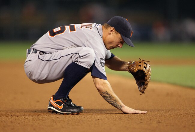 KANSAS CITY, MO - JULY 07:  Brandon Inge #15 of the Detroit Tigers rubs the dirt during the game against the Kansas City Royals on July 7, 2011 at Kauffman Stadium in Kansas City, Missouri.  (Photo by Jamie Squire/Getty Images)