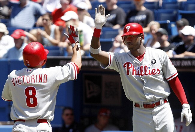 TORONTO, CANADA - JULY 3: Shane Victorino #8 and Domonic Brown #9 of the Philadelphia Phillies celebrate 2-run RBI by Jimmy Rollins against the Toronto Blue Jays during MLB action at The Rogers Centre July 3, 2011 in Toronto, Ontario, Canada. (Photo by Abelimages/Getty Images)