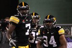 TEMPE, AZ - DECEMBER 28:  Runningback Marcus Coker #34 of the Iowa Hawkeyes celebrates with teammates with Marvin McNutt #1 and Colin Sandeman #22 after scoring on a 64 yard rushing touchdown against the Missouri Tigers during the second quarter of the Insight Bowl at Sun Devil Stadium on December 28, 2010 in Tempe, Arizona.  (Photo by Christian Petersen/Getty Images)