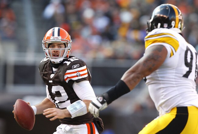 CLEVELAND, OH - JANUARY 02:  Quarterback Colt McCoy #12 of the Cleveland Browns looks for a receiver as he is chased by defensive end Ziggy Hood #96 of the Pittsburgh Steelers at Cleveland Browns Stadium on January 2, 2011 in Cleveland, Ohio.  (Photo by Matt Sullivan/Getty Images)