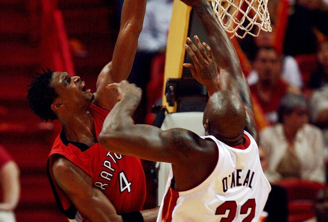 MIAMI - APRIL 03:  Shaquille O'Neal #32 of the Miami Heat tries to stop Chris Bosh #4 of the Toronto Raptors at American Airlines Arena on April 3,  2007 in Miami, Florida. The Heat defeated the Raptors 92-89. NOTE TO USER: User expressly acknowledges and agrees that, by downloading and or using this photograph, User is consenting to the terms and conditions of the Getty Images License Agreement.  (Photo by Doug Benc/Getty Images)
