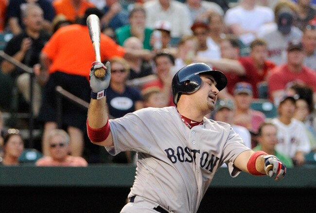 BALTIMORE, MD - JULY 19: Adrian Gonzalez #28 of the Boston Red Sox strikes out swing for the second out of the fourth inning against the Baltimore Orioles at Oriole Park at Camden Yards on July 19, 2011 in Baltimore, Maryland.  (Photo by Rob Carr/Getty Images)