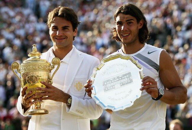 LONDON - JULY 08:  Roger Federer of Switzerland poses with the winners trophy alongside runner-up Rafael Nadal of Spain following the Men's Singles final match during day thirteen of the Wimbledon Lawn Tennis Championships at the All England Lawn Tennis and Croquet Club on July 8, 2007 in London, England. Roger Federer claims his fifth consecutive championship title.  (Photo by Clive Brunskill/Getty Images)