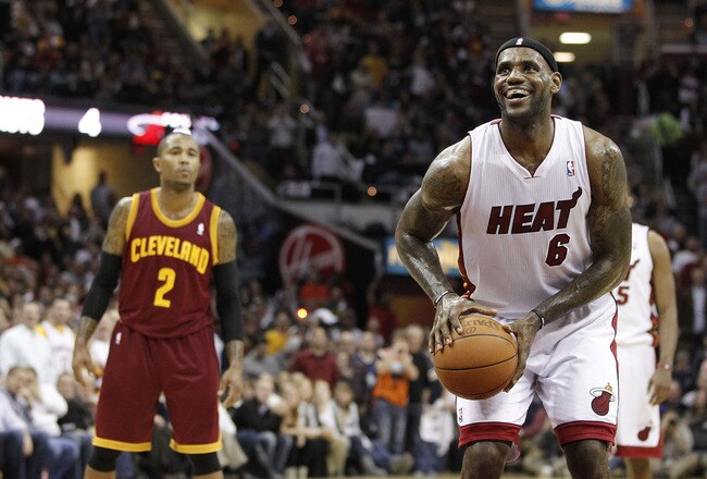 CLEVELAND, OH - DECEMBER 02:  LeBron James #6 of the Miami Heat smiles while takeing a free throw in front of Mo Williams #2 of the Cleveland Cavaliers at Quicken Loans Arena on December 2, 2010 in Cleveland, Ohio. NOTE TO USER: User expressly acknowledges and agrees that, by downloading and or using this photograph, User is consenting to the terms and conditions of the Getty Images License Agreement.  (Photo by Gregory Shamus/Getty Images)