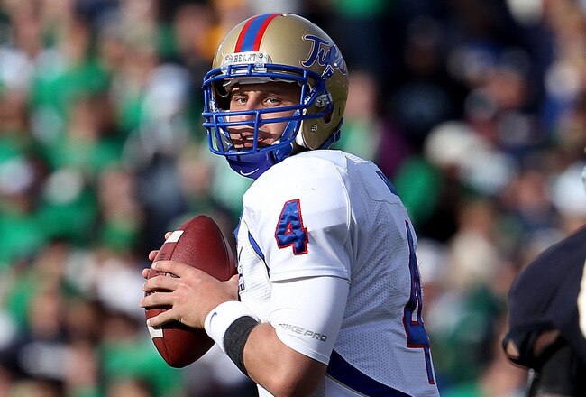 SOUTH BEND, IN - OCTOBER 30: G.J. Kinne #4 of the Tulsa Golden Hurricane looks to pass as Darius Flemming #45 of the Notre Dame Fighting Irish rushes at Notre Dame Stadium on October 30, 2010 in South Bend, Indiana. Tulsa defeated Notre Dame 28-27. (Photo by Jonathan Daniel/Getty Images)