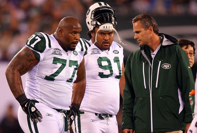 EAST RUTHERFORD, NJ - SEPTEMBER 13:  Kris Jenkins #77 of the New York Jets  comes out of the game after getting injured while playing against the Baltimore Ravens as Sione Pouha #91 looks on during their home opener at the New Meadowlands Stadium on September 13, 2010 in East Rutherford, New Jersey.  (Photo by Andrew Burton/Getty Images)