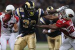 ST. LOUIS - SEPTEMBER 12: Steven Jackson #39 of the St. Louis Rams looks to get past Adrian Wilson #24 of the Arizona Cardinals during the NFL season opener at the Edward Jones Dome on September 12, 2010 in St. Louis, Missouri.  The Cardinals beat the Rams 17-13.  (Photo by Dilip Vishwanat/Getty Images)