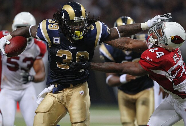 ST. LOUIS - SEPTEMBER 12: Steven Jackson #39 of the St. Louis Rams looks to get past Adrian Wilson #24 of the Arizona Cardinals during the NFL season opener at the Edward Jones Dome on September 12, 2010 in St. Louis, Missouri.  The Cardinals beat the Rams 17-13.  (Photo by Dilip Vishwanat/Getty Images)