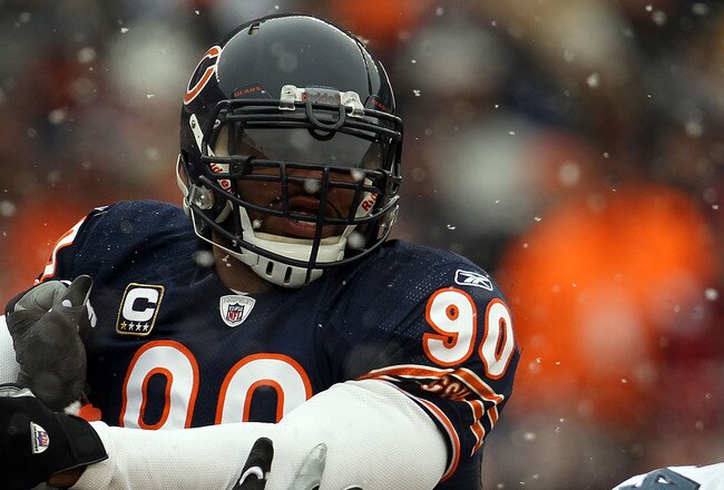 CHICAGO, IL - JANUARY 16:  Julius Peppers #90 of the Chicago Bears is blocked by Chris Spencer #65 of the Seattle Seahawks in the 2011 NFC divisional playoff game at Soldier Field on January 16, 2011 in Chicago, Illinois.  (Photo by Jonathan Daniel/Getty Images)