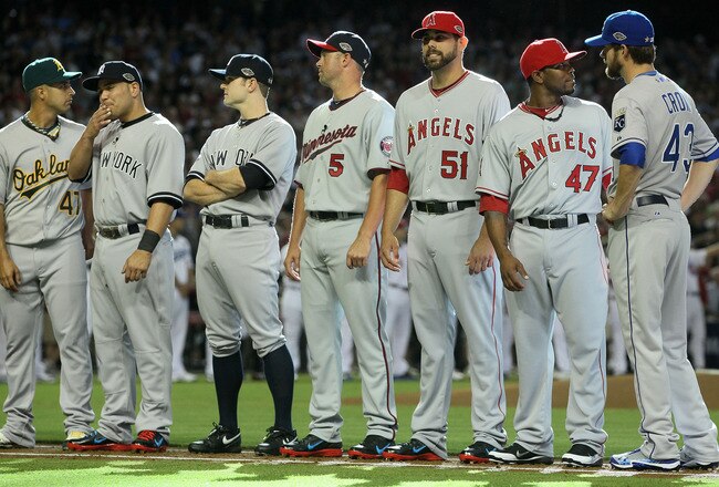 PHOENIX, AZ - JULY 12:  American League All-Star Gio Gonzalez #47 of the Oakland Athletics stands with American League All-Star Russell Martin #55 of the New York Yankees, American League All-Star David Robertson #30 of the New York Yankees, American League All-Star Michael Cuddyer #5 of the Minnesota Twins, American League All-Star Jordan Walden #51 of the Los Angeles Angels, American League All-Star Howard Kendrick #47 of the Los Angeles Angels and American League All-Star Aaron Crow #43 of the Kansas City Royals before the start of the 82nd MLB All-Star Game at Chase Field on July 12, 2011 in Phoenix, Arizona.  (Photo by Jeff Gross/Getty Images)