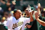 OAKLAND, CA - JUNE 30:  Coco Crisp #4 of the Oakland Athletics is congratulated by teammates after he hit a home run in the eighth inning against the Florida Marlins at Oakland-Alameda County Coliseum on June 30, 2011 in Oakland, California.  (Photo by Ezra Shaw/Getty Images)