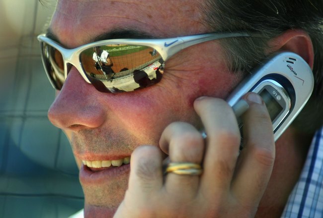 PHOENIX - MARCH 03:  General manager Billy Beane of the Oakland Athletics talks on the phone during the MLB Spring Training game against the Milwaukee Brewers at Phoenix Municipal Stadium on March 3, 2006 in Phoenix, Arizona.  The Brewers defeated the A's 5-1.   (Photo by Christian Petersen/Getty Images)
