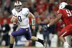 TUCSON, AZ - OCTOBER 23:  Quarterback Jake Locker #10 of the Washington Huskies scrambles with the football during the college football game against the Arizona Wildcats at Arizona Stadium on October 23, 2010 in Tucson, Arizona.  (Photo by Christian Petersen/Getty Images)