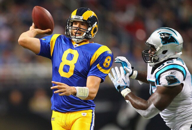 ST. LOUIS - OCTOBER 31: Sam Bradford #8 of the St. Louis Rams looks to pass against Eric Norwood #92 of the Carolina Panthers at the Edward Jones Dome on October 31, 2010 in St. Louis, Missouri.  The Rams beat the Panthers 20-10.  (Photo by Dilip Vishwanat/Getty Images)