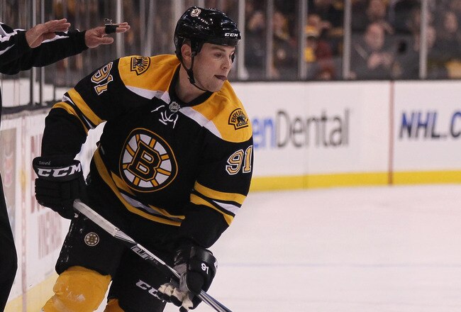 BOSTON, MA - DECEMBER 02:  Marc Savard #91 of the Boston Bruins takes the puck in the first period against the Tampa Bay Lightning on December 2, 2010 at the TD Garden in Boston, Massachusetts.  (Photo by Elsa/Getty Images)