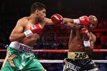 LAS VEGAS, NV - JULY 23:  (L-R) Amir Khan throws a left at Zab Judah in the first round during their super lightweight world championship unification bout at Mandalay Bay Events Center on July 23, 2011 in Las Vegas, Nevada.  (Photo by Scott Heavey/Getty Images)