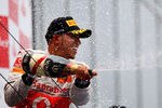 NUERBURG, GERMANY - JULY 24:  Lewis Hamilton of Great Britain and McLaren celebrates on the podium after winning the German Formula One Grand Prix at the Nurburgring on July 24, 2011 in Nuerburg, Germany.  (Photo by Clive Mason/Getty Images)