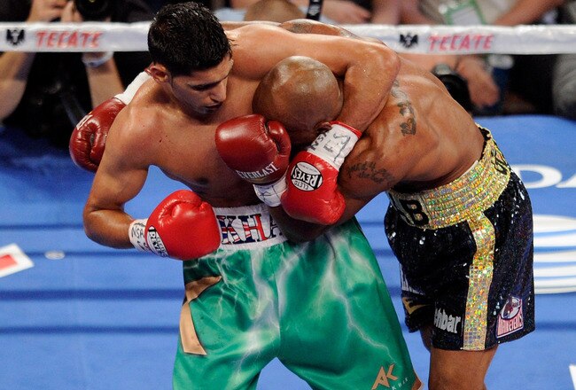 LAS VEGAS, NV - JULY 23:  (L-R) Amir Khan holds Zab Judah during their super lightweight world championship unification bout at Mandalay Bay Events Center on July 23, 2011 in Las Vegas, Nevada.  (Photo by Ethan Miller/Getty Images)