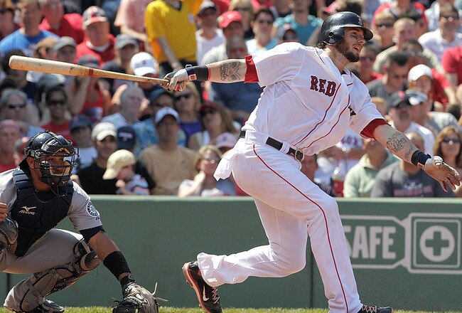 BOSTON, MA  - JULY 24:  Jarrod Saltalamacchia #39 of the Boston Red Sox makes contact during a game against the Seattle Mariners at Fenway Park on July 24, 2011 in Boston, Massachusetts.  (Photo by Jim Rogash/Getty Images)