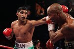 LAS VEGAS, NV - JULY 23:  (L-R) Amir Khan throws a left at Zab Judah during their super lightweight world championship unification bout at Mandalay Bay Events Center on July 23, 2011 in Las Vegas, Nevada.  (Photo by Scott Heavey/Getty Images)