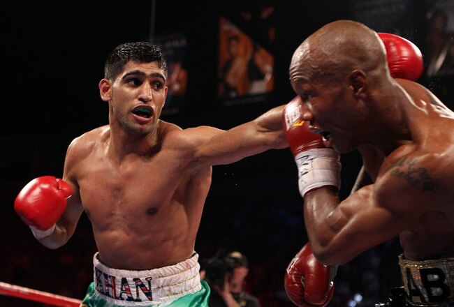 LAS VEGAS, NV - JULY 23:  (L-R) Amir Khan throws a left at Zab Judah during their super lightweight world championship unification bout at Mandalay Bay Events Center on July 23, 2011 in Las Vegas, Nevada.  (Photo by Scott Heavey/Getty Images)