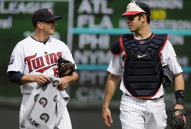 MINNEAPOLIS, MN - MAY 26: Brian Duensing #52 and Joe Mauer #7 of the Minnesota Twins walk in from the bullpen prior to the continuation of their rain suspended game from the night before against the New York Yankees on May 26, 2010 at Target Field in Minneapolis, Minnesota. The game was suspended due to rain after the fifth inning on Tuesday and resumed on Wednesday. The Yankees defeated the Twins 1-0. (Photo by Hannah Foslien/Getty Images)