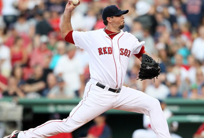 BOSTON, MA - JULY 23: Josh Beckett #19 of the Boston Red Sox delivers a pitch in the first inning against the Seattle Mariners on July 23, 2011 at Fenway Park in Boston, Massachusetts.  (Photo by Elsa/Getty Images)