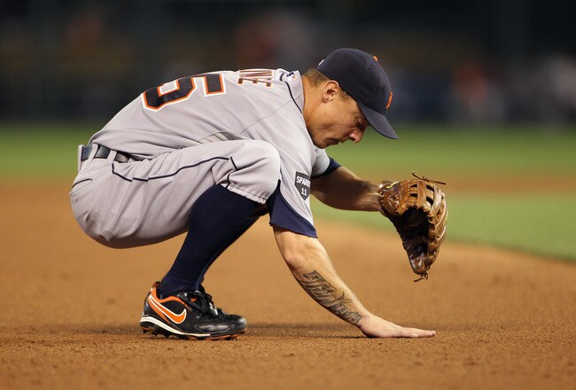 KANSAS CITY, MO - JULY 07:  Brandon Inge #15 of the Detroit Tigers rubs the dirt during the game against the Kansas City Royals on July 7, 2011 at Kauffman Stadium in Kansas City, Missouri.  (Photo by Jamie Squire/Getty Images)