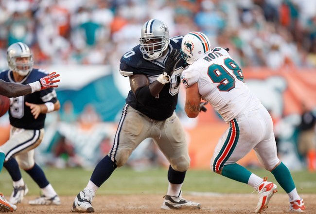 MIAMI - SEPTEMBER 16: Offensive tackle Leonard Davis #70 of the Dallas Cowboys holds off defensive end Matt Roth #98 at Dolphin Stadium on September 16, 2007 in Miami, Florida. The Cowboys defeated the Dolphins 37-20.  (Photo by Allen Kee/Getty Images)