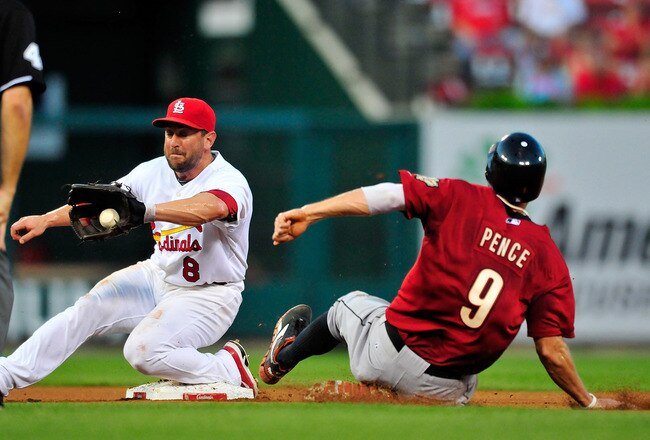ST. LOUIS, MO - JULY 25: Nick Punto #8 of the St. Louis Cardinals fields a throw as Hunter Pence #9 of the Houston Astros attempts to steal second base at Busch Stadium on July 25, 2011 in St. Louis, Missouri.  (Photo by Jeff Curry/Getty Images)