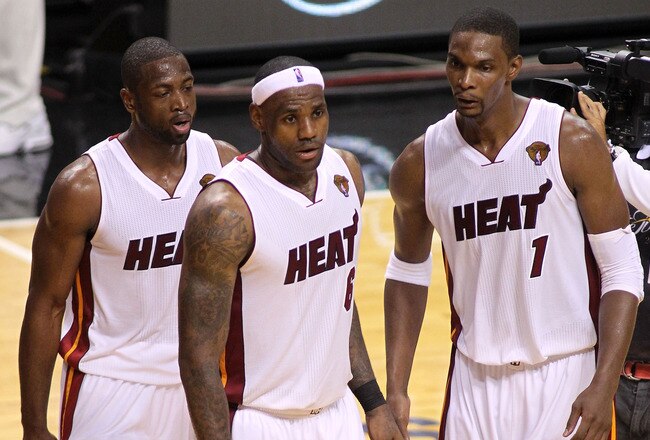 MIAMI, FL - MAY 31:  Dwyane Wade #3, LeBron James #6 and Chris Bosh #1 of the Miami Heat react after the Heat defeat the Dallas Mavericks 92-84 in Game One of the 2011 NBA Finals at American Airlines Arena on May 31, 2011 in Miami, Florida. NOTE TO USER: User expressly acknowledges and agrees that, by downloading and/or using this Photograph, user is consenting to the terms and conditions of the Getty Images License Agreement.  (Photo by Marc Serota/Getty Images)