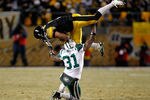 PITTSBURGH, PA - JANUARY 23:  Mewelde Moore #21 of the Pittsburgh Steelers catches a pass over Antonio Cromartie #31 of the New York Jets in the third quarter of the 2011 AFC Championship game at Heinz Field on January 23, 2011 in Pittsburgh, Pennsylvania. The Steelers defeated the Jets 24 to 19.  (Photo by Gregory Shamus/Getty Images)