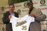 OAKLAND, CA - JANUARY 26:  Frank Thomas (R) and general manager Billy Beane of the Oakland Athletics hold Thomas's new jersey at a press conference after he signed a one-year contract with the team at McAfee Coliseum on January 26, 2006 in Oakland, California.  (Photo by Jed Jacobsohn/Getty Images)