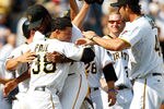 PITTSBURGH - JULY 24:  Xavier Paul #38 of the Pittsburgh Pirates is congratulated by teammates James McDonald #53 and Garrett Jones #46 after scoring the game winning run in the 10th inning against the St Louis Cardinals during the game on July 24, 2011 at PNC Park in Pittsburgh, Pennsylvania.  (Photo by Jared Wickerham/Getty Images)