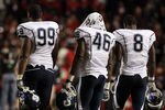 PISCATAWAY, NJ - OCTOBER 08:  Kendall Reyes #99, Sio Moore #46 and Lawrence Wilson #8 of the Connecticut Huskies walk off the field after losing against the Rutgers Scarlet Knights at Rutgers Stadium on October 8, 2010 in Piscataway, New Jersey. Rutgers defeated UConn 27-24.  (Photo by Jim McIsaac/Getty Images)