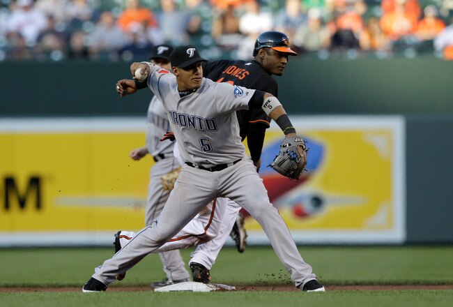BALTIMORE, MD - JUNE 03:  Yunel Escobar #5 of the Toronto Blue Jays throws to first base for a double play after forcing out Adam Jones #10 of the Baltimore Orioles out at second base during the first inning at Oriole Park at Camden Yards on June 3, 2011 in Baltimore, Maryland.  The Blue Jays won 8-4. (Photo by Rob Carr/Getty Images)