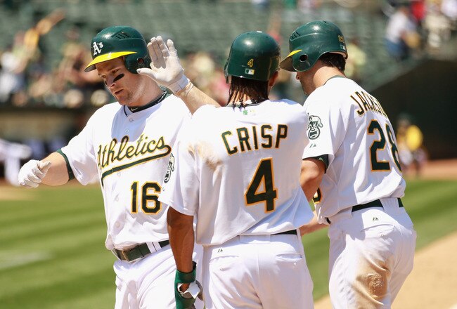 OAKLAND, CA - MAY 29:  Josh Willingham #16 of the Oakland Athletics is congratulated by Coco Crisp #4 and Conor Jackson #28 after he hit a home run to score them allin the fifth inning against the Baltimore Orioles at Oakland-Alameda County Coliseum on May 29, 2011 in Oakland, California.  (Photo by Ezra Shaw/Getty Images)