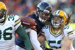 CHICAGO, IL - JANUARY 23:  (C) Tight end Greg Olsen #82 of the Chicago Bears knocks down a pass intended for him that was nearly intercepted by Nick Collins #36 and Clay Matthews #52 of the Green Bay Packers in the second quarter in the NFC Championship Game at Soldier Field on January 23, 2011 in Chicago, Illinois.  (Photo by Andy Lyons/Getty Images)