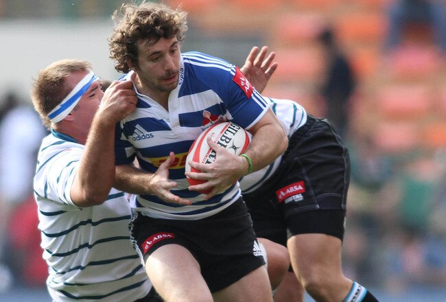 CAPE TOWN, SOUTH AFRICA - JULY 16: Western Province centre Tim Whitehead attempts to break through Griquas lock Hendrik Roodt and Griquas prop Steph Roberts' tackle during the Absa Currie Cup match between DHL Western Province and GWK Griquas at DHL Newlands Stadium on July 16, 2011 in Cape Town, South Africa. (Photo by Shaun Roy/Gallo Images/Getty Images)