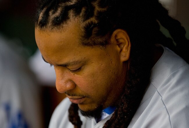 ST. LOUIS - JULY 18: Manny Ramirez #99 of the Los Angeles Dodgers sits in the dugout against the St. Louis Cardinals at Busch Stadium on July 18, 2010 in St. Louis, Missouri.  (Photo by Dilip Vishwanat/Getty Images)