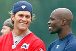 FOXBOROUGH, MA  - JULY 29:  Tom Brady #12 and Chad Ochocinco of the New England Patriots chat during training camp at Gillette Stadium on July 29, 2011 in Foxborough, Massachusetts.  (Photo by Jim Rogash/Getty Images)