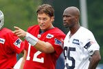 FOXBOROUGH, MA  - JULY 29:  Tom Brady #12 and Chad Ochocinco #85 of the New England Patriots chats during the afternoon session of training camp at Gillette Stadium on July 29, 2011 in Foxborough, Massachusetts.  (Photo by Jim Rogash/Getty Images)